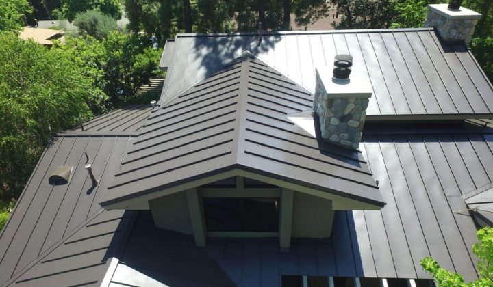 Gray metal roof on a building surrounded by trees